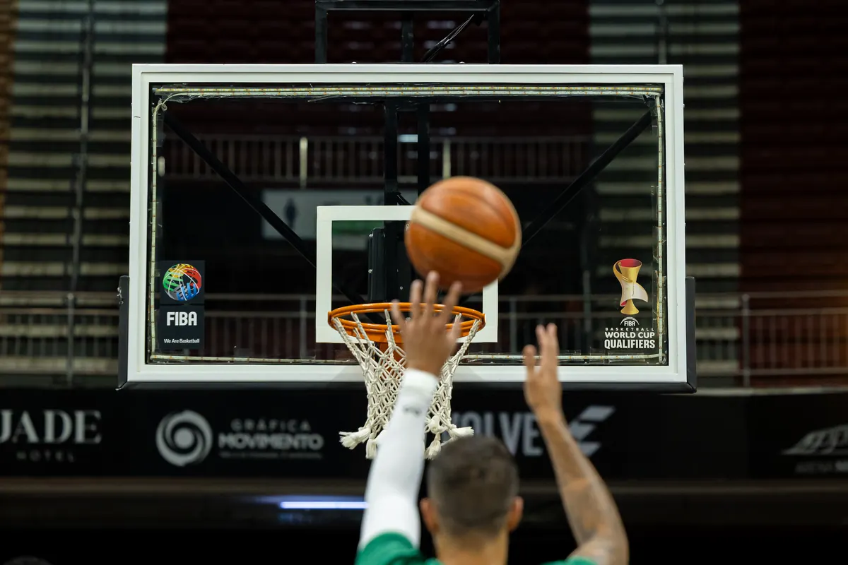 Free throw in flight toward the rim, under the FIBA World Cup Qualifiers backboard