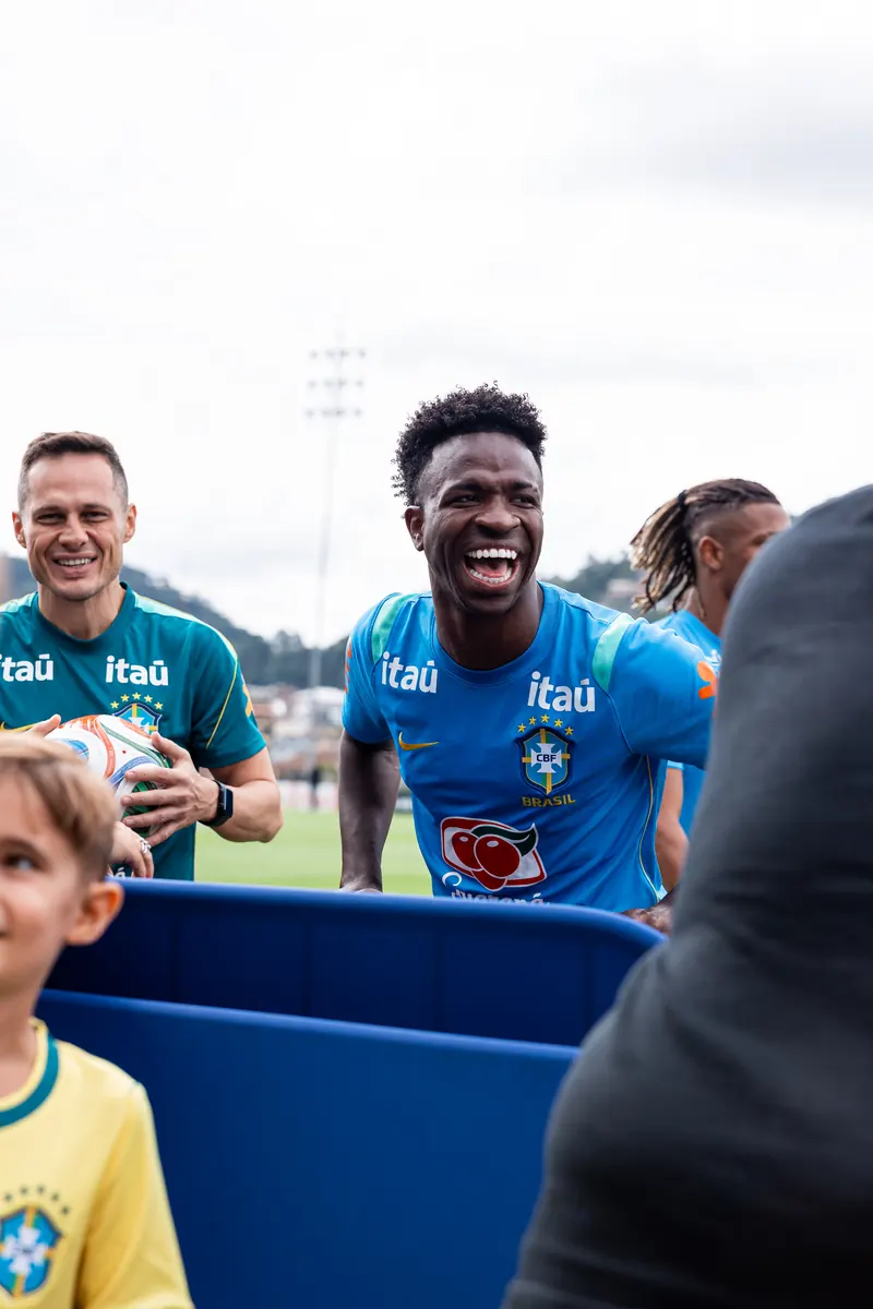 Brazil player laughing with fans at training