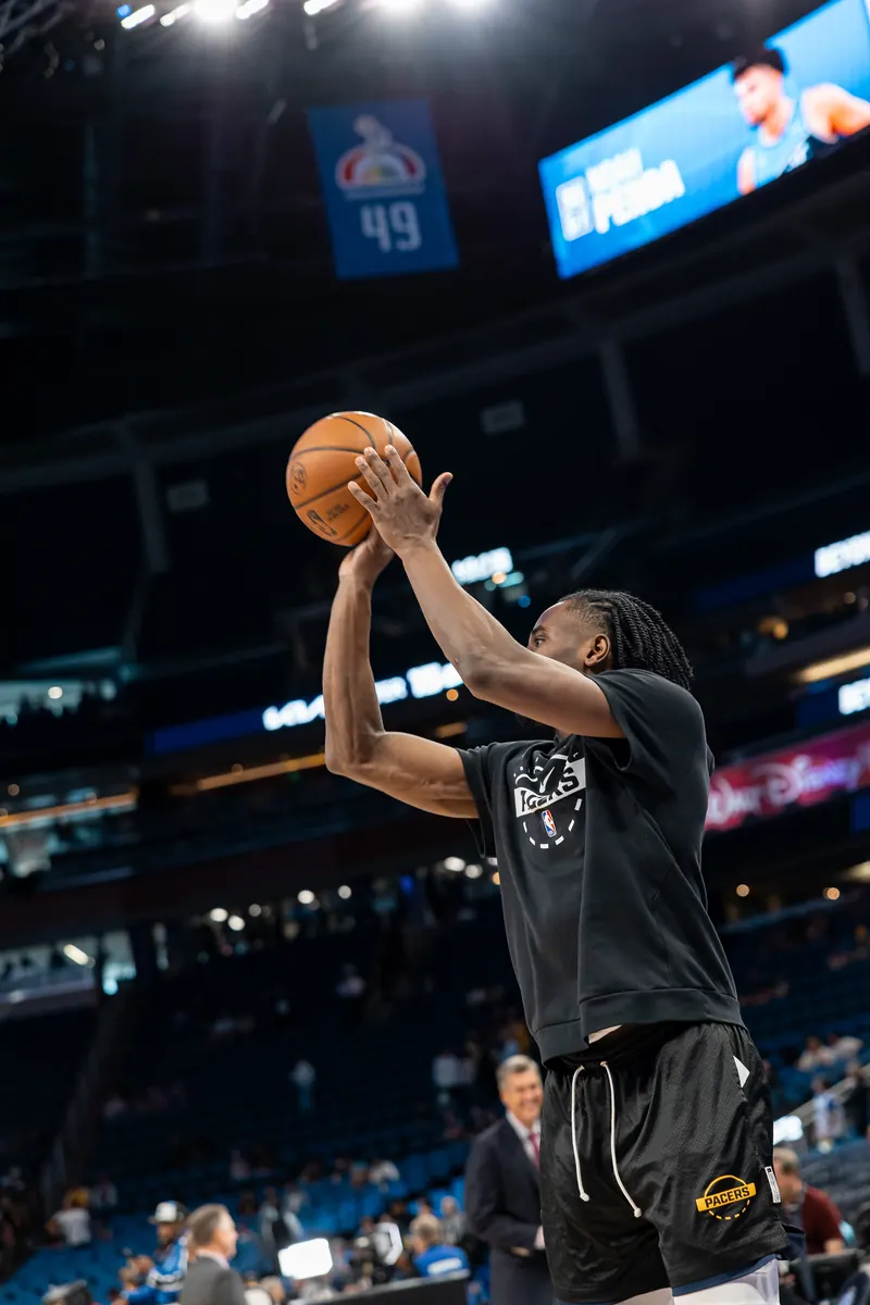 Player rising for a warm-up jumper under the arena lights
