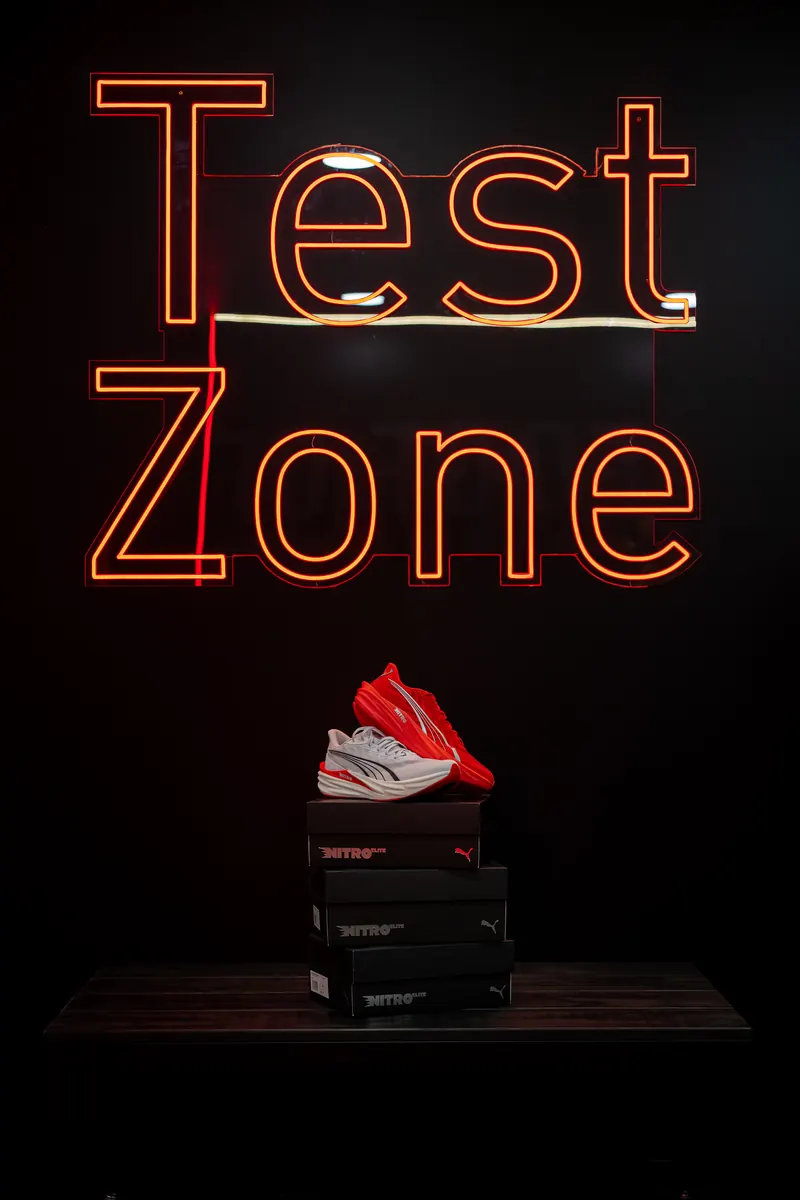 Test Zone neon sign above a Puma Nitro shoe
